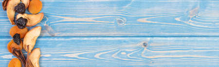 Frame of dried fruits for preparing beverage or compote, healthy nutrition, copy space for text or inscription on boardsの写真素材