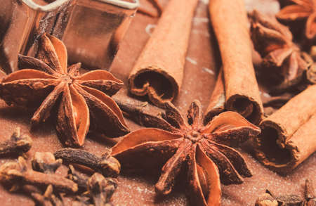 Cookie cutters and spices on dough for gingerbread or festive cookies. Baking and Christmas time