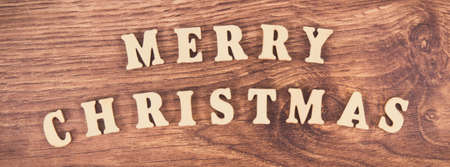 Vintage photo, Inscription Merry Christmas on rustic board, concept of festive timeの写真素材