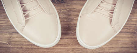 Vintage photo, Womanly pink leather shoes lying on rustic boardの写真素材
