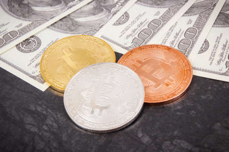 Bitcoin coins as symbol of cryptocurrency and dollar, concept of modern finance and bankingの写真素材