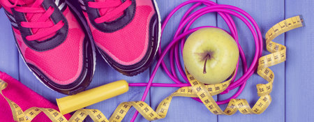 Pair of sport shoes, accessories for fitness and fresh apple. Healthy sporty lifestylesの写真素材