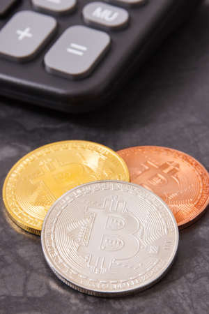 Bitcoins and calculator, concept of cryptocurrency and international network paymentの写真素材