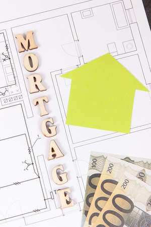 Money on electrical diagrams, concept of mortgage loan for buying house