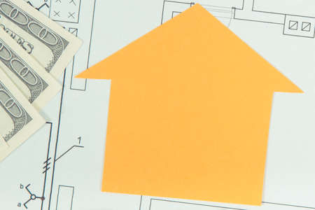 Home shape and money on electrical construction drawing, concept of selling and buying houseの写真素材