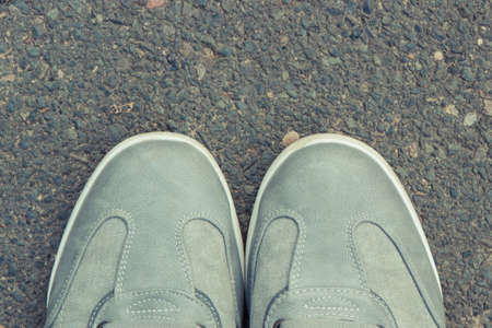 Comfortable casual gray leather shoes for men on asphalt road or footpath. Male footwearの写真素材
