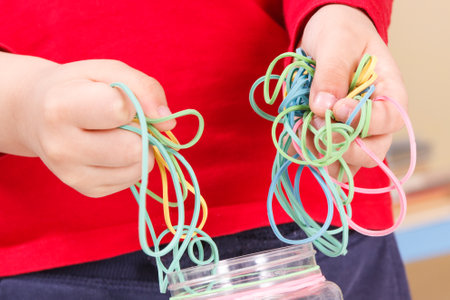 Preschooler playing with colorful rubber erasers. Development of kids motor skills, coordination,...