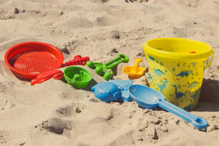 Children plastic toys for relax or playing on sand at beach. Summer, vacation time and child developmentの写真素材