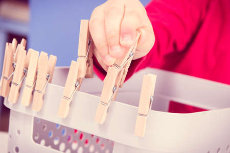 Preschooler playing with wooden clip. Development of kids motor skills, coordination and creativity