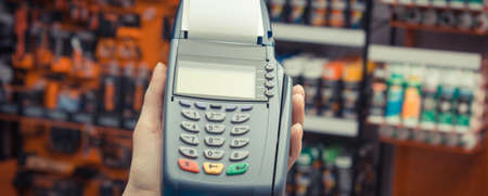 Hand of woman using payment terminal with credit card.の写真素材