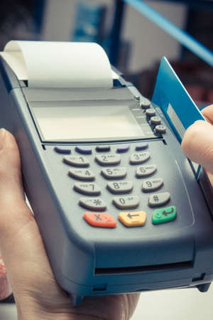 Payment terminal with credit card as device using for cashless paying for shopping in shop.の写真素材