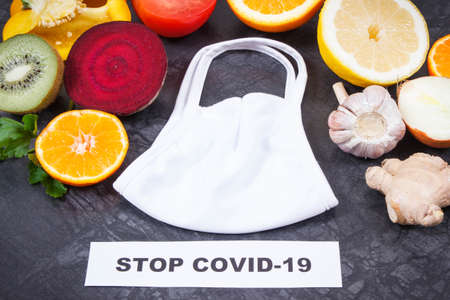 Fresh ripe fruits and vegetables as source healthy vitamins and minerals and protective mask. Strengthening immunity in times of epidemics Covid-19の写真素材