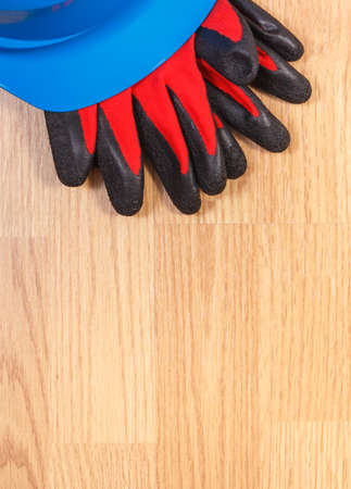 Protective blue helmet and gloves, accessories for engineer jobs, copy space for text on board