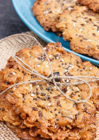 Fresh baked homemade oatmeal cookies on jute canvas. Delicious crunchy dessertの写真素材