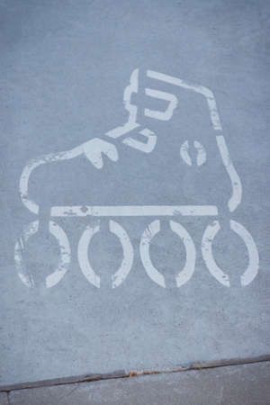 Sign of rolls on asphalt street or sidewalk. Safety during active restingの写真素材