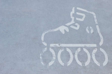 Sign of rolls on asphalt street or sidewalk. Safety during active resting. Marking for skatersの写真素材