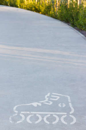 Sign of rolls on asphalt street or sidewalk. Safety during active restingの写真素材