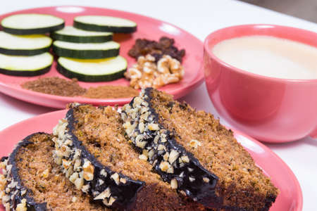 Fresh baked homemade zucchini dough and cup of white coffee. Delicious dessert. White backgroundの写真素材