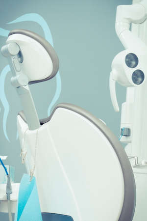 Dental chair with tools and accessories for using by dentists in modern stomatology officeの写真素材