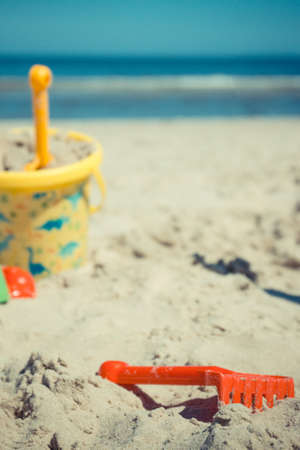 Children plastic toys using for relax and playing on sand at beach. Summer, vacation time and child developmentの写真素材