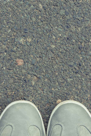 Comfortable casual gray leather shoes for men on asphalt road or footpath. Male footwear. Place for...