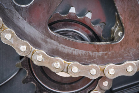 Metal chain and gear as detail and part of agricultural and industrial machine. Technology concept