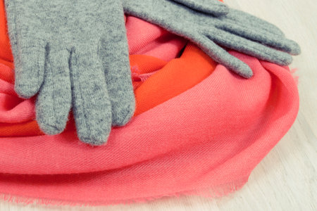 Colorful gloves and shawl for woman made of wool or cotton, concept of warm clothing for autumn or winterの写真素材