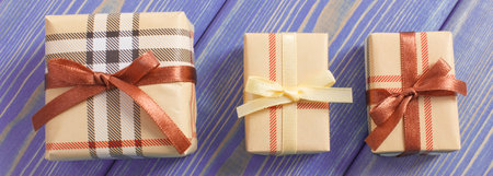 Wrapped colorful gifts with ribbons for Christmas, Valentine, birthday or other celebration lying on...