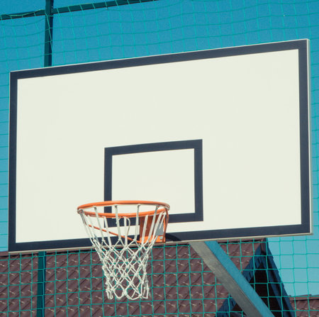 Basketball board with hoop on sky background. Sport and recreation time