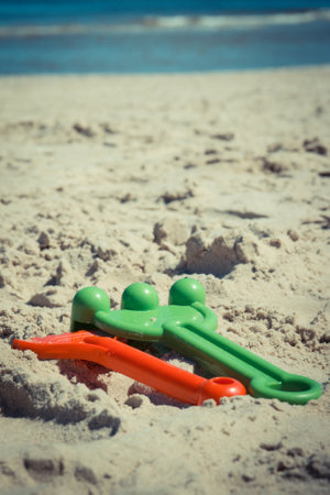 Children plastic toys for relax or playing on sand at beach. Summer, vacation time and child developmentの写真素材