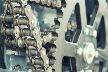 Metal chain and gear as detail and part of agricultural and industrial machine. Technology concept