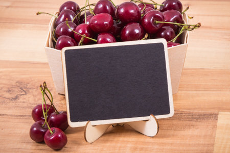 Cherries as healthy snack or dessert. Place for text or inscription on boardの写真素材