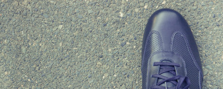Comfortable casual navy blue leather shoes for men on asphalt road or footpath. Male footwear. Place for text or inscriptionの写真素材