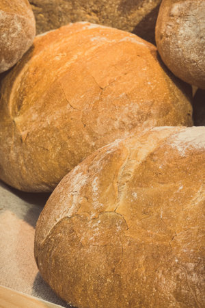 Freshly traditional loaves of wheat or rye bread on stall or in bakeryの写真素材