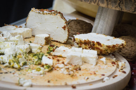 Fresh smoked cheese with spices for sale on stall or in grocery shop
