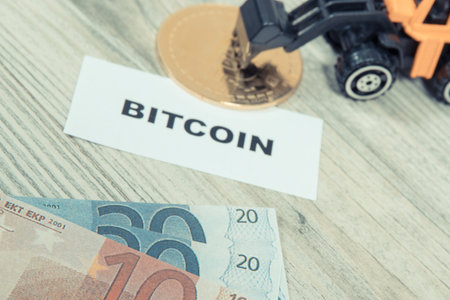 Bitcoin, miniature excavator and euro. Symbol of cryptocurrency. International network payments. Finance conceptの写真素材