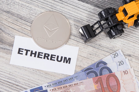 Ethereum, miniature excavator and euro. Symbol of cryptocurrency. International network payments. Finance conceptの写真素材