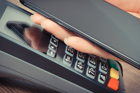 Mobile phone or smartphone with payment terminal. Credit card reader. Cashless paying for shopping. Finance and banking conceptの写真素材