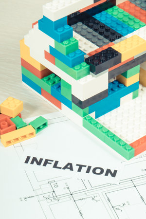 Electrical diagrams of house with building under construction made of colorful toy blocks and...