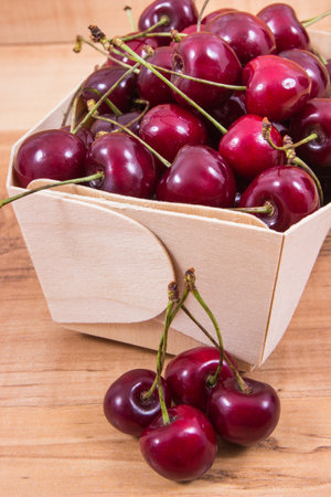 Fresh ripe juicy cherries in container. Dessert or snackの写真素材