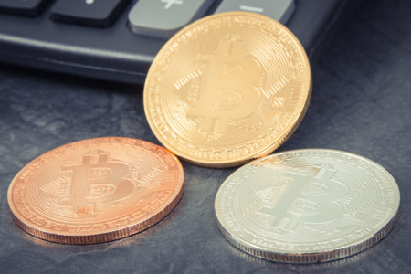 Bitcoin coins with calculator. Symbol of cryptocurrency and international network payment. Finance conceptの写真素材