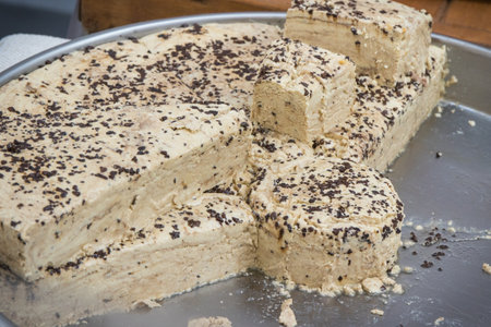 Portion of halva with vanilla and chocolate on stall at bazaar. High calorie snack