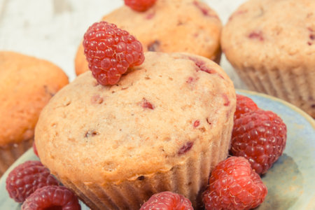 Fresh baked homemade muffins with raspberries and chocolate. Delicious dessert for different occasionsの写真素材