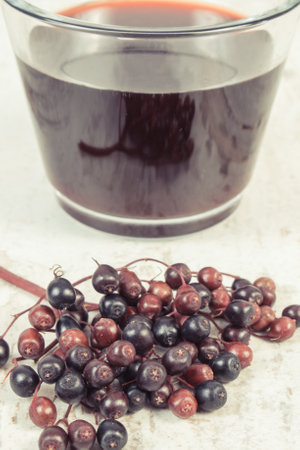 Fresh elderberry juice and ripe fruits containing natural vitamins and minerals. Healthy nutrition...