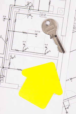 Diagram of electric installation, yellow shape of house and key. Planning build of home. Technologyの写真素材