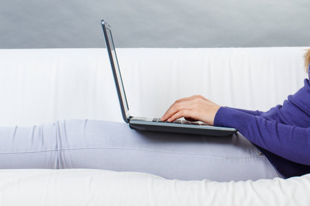 Hands of woman with laptop. Relaxing or working with computer. Modern technologyの写真素材