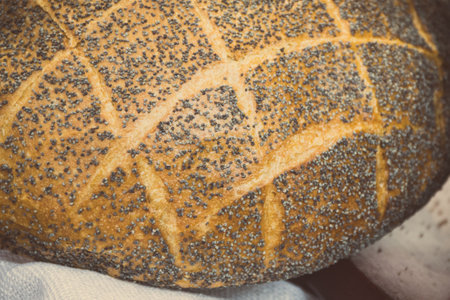 Freshly baked traditional loaf of wheat or rye bread on stall or in grocery shop