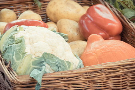 Fresh nutritious vegetables in wicker basket as ingredients containing healthy minerals and vitaminsの写真素材