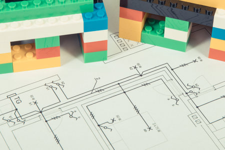Small houses made of colorful toy blocks, housing plan with electric installation. Subject of building or renting homeの写真素材