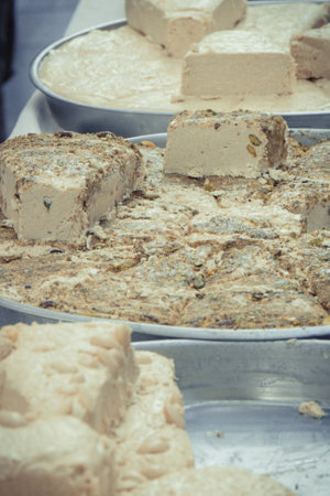 Portion of halva with vanilla and pistachio on stall at bazaar. High calorie snackの写真素材